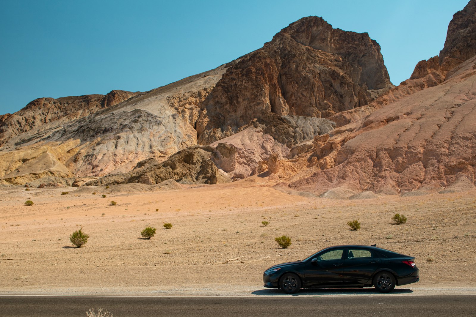A car driving down a road in the desert