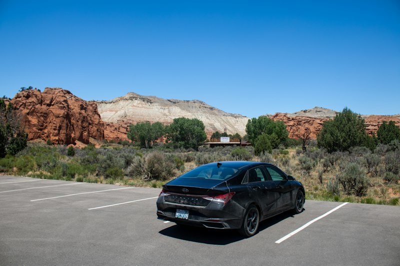A black car parked in a parking lot